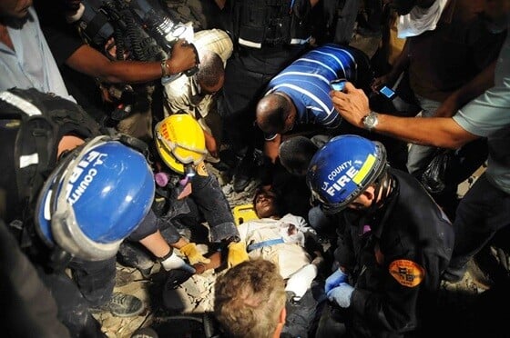 USAID partners rescue a woman from a collapsed building in downtown Port-au-Prince days after the 2010 earthquake.