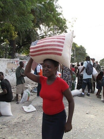 A Haitian woman receives a ration of rice at a USAID distribution point.